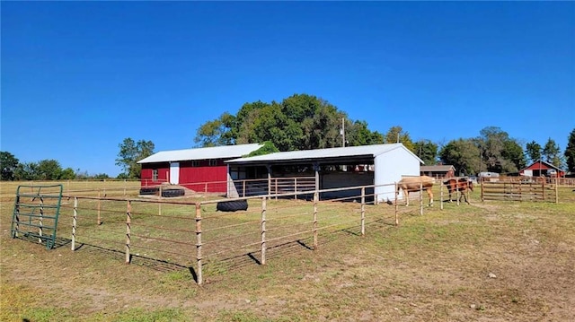 view of horse barn featuring a rural view