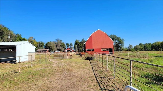 view of yard featuring a rural view and an outdoor structure