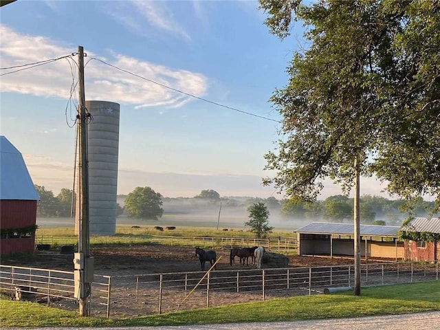 view of community featuring an outdoor structure and a rural view