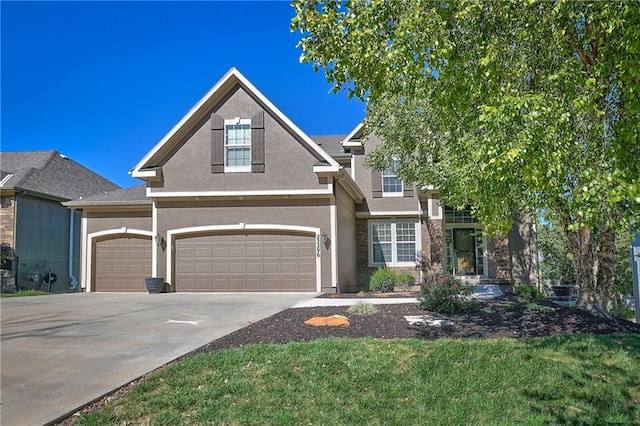 view of front facade with a garage and a front lawn