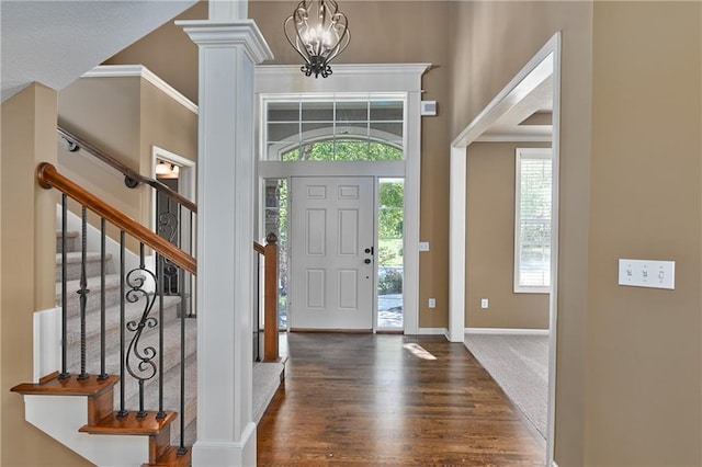 foyer with a notable chandelier and dark hardwood / wood-style flooring