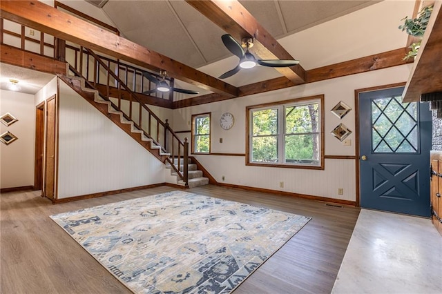 entrance foyer with light hardwood / wood-style flooring, ceiling fan, and vaulted ceiling