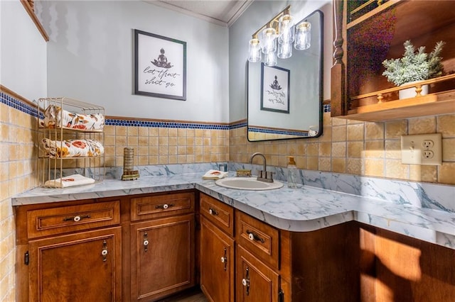 bathroom featuring tile walls, vanity, and crown molding