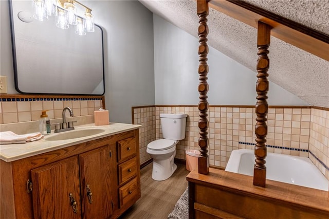 bathroom featuring hardwood / wood-style floors, toilet, a bathing tub, tile walls, and a textured ceiling