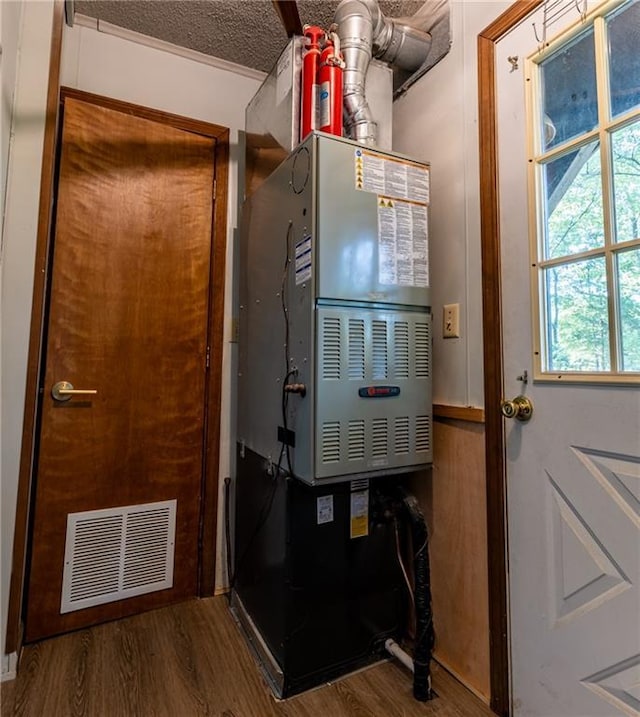 utility room with heating unit and visible vents