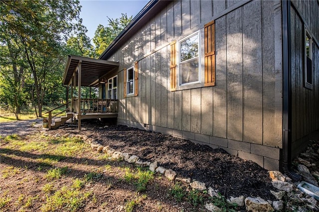 view of side of property featuring a wooden deck