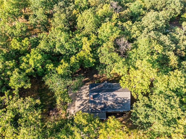 drone / aerial view with a wooded view