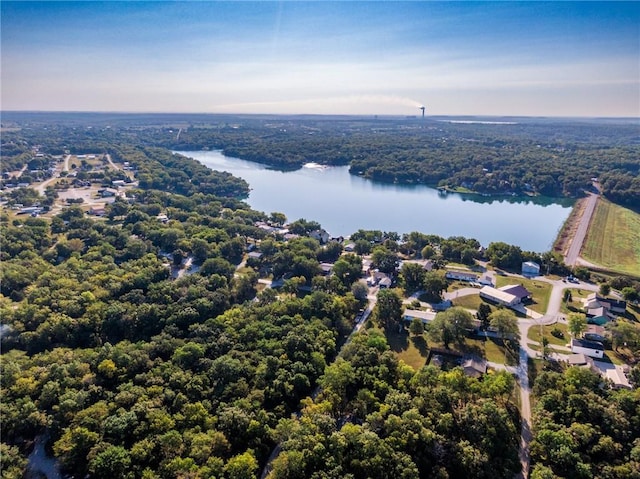 aerial view with a forest view and a water view