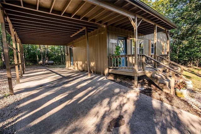 view of patio with a carport and driveway