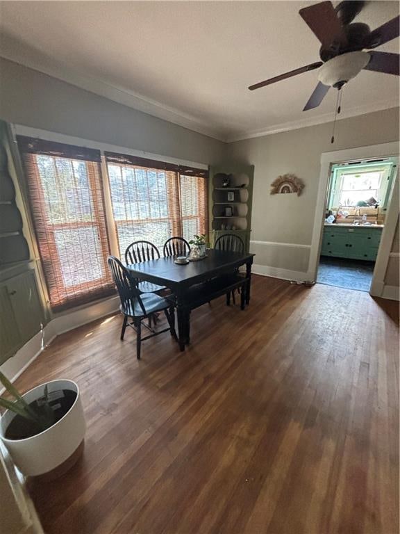 dining room with ceiling fan, dark wood-type flooring, and ornamental molding