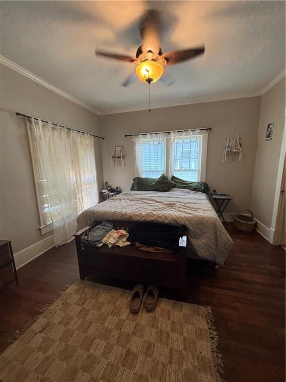 bedroom featuring ceiling fan, dark hardwood / wood-style floors, and ornamental molding