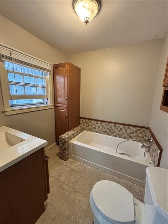 bathroom featuring a garden tub, toilet, vanity, and tile patterned floors