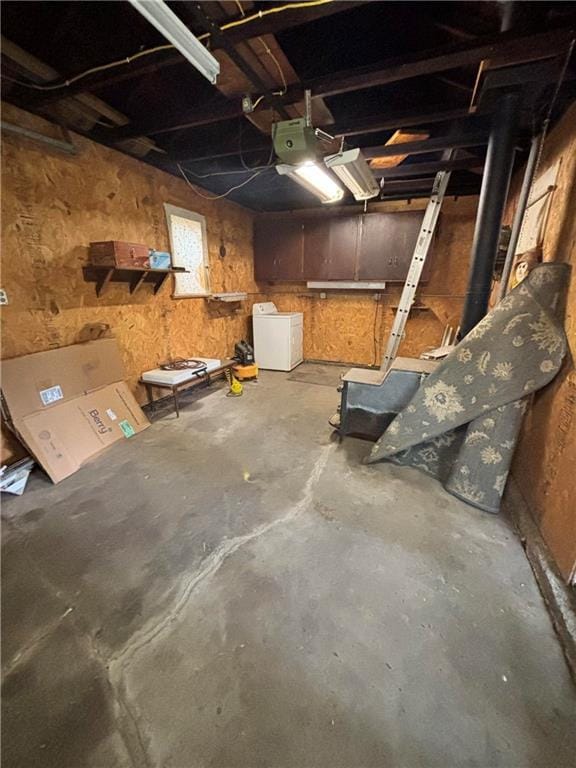 basement with a garage and washer / dryer