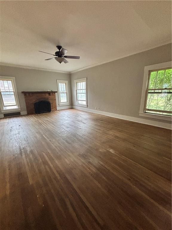 unfurnished living room featuring ceiling fan, baseboards, wood finished floors, and ornamental molding