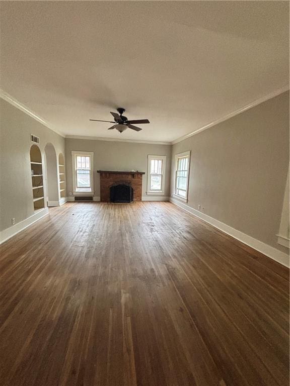 unfurnished living room with visible vents, a ceiling fan, a healthy amount of sunlight, and crown molding