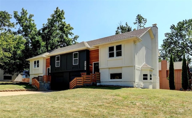 raised ranch featuring a front lawn