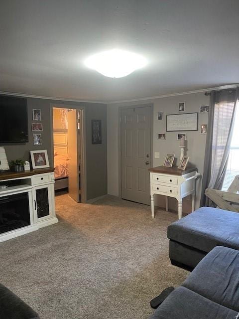 carpeted living room with ornamental molding and a fireplace