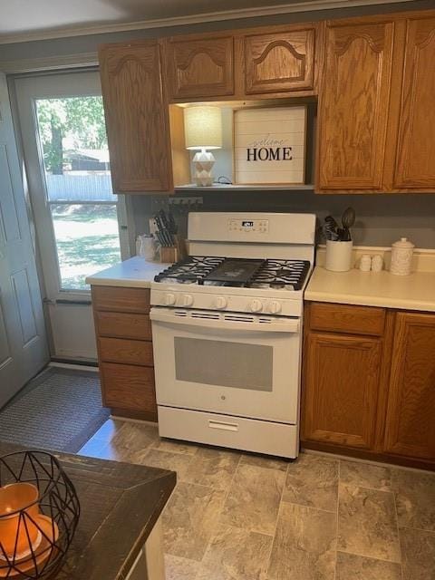 kitchen featuring crown molding and white gas range