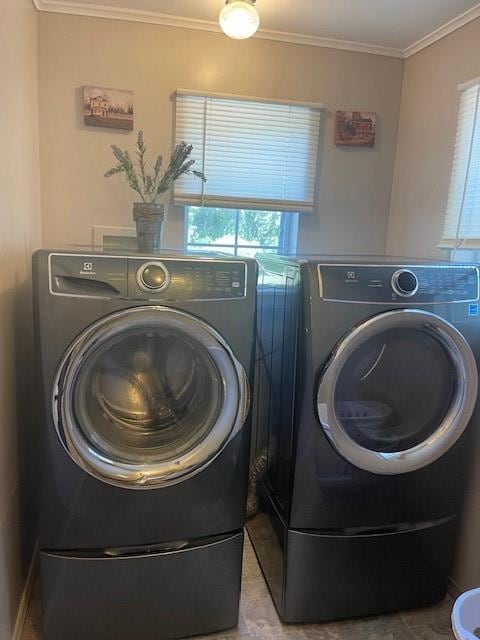 laundry room featuring washer and clothes dryer and ornamental molding