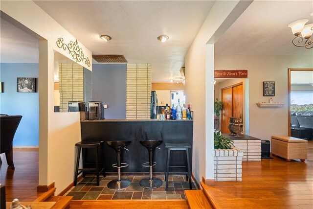 interior space with dark wood-type flooring and a notable chandelier