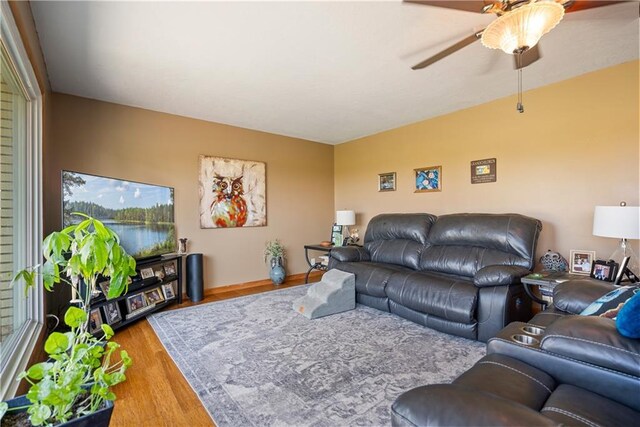 living room featuring ceiling fan and light hardwood / wood-style floors