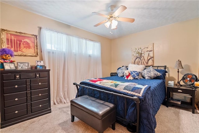 bedroom with light colored carpet and ceiling fan