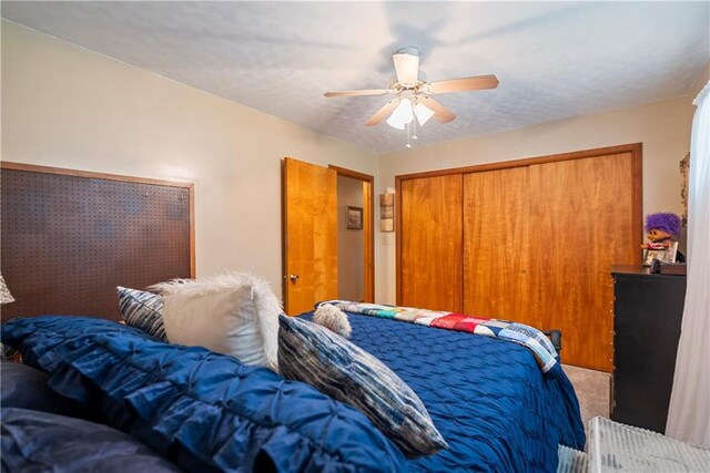 bedroom with ceiling fan, a closet, and carpet floors