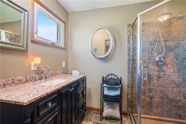 bathroom featuring vanity and an enclosed shower