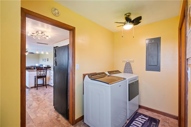 laundry area with electric panel, washing machine and dryer, and ceiling fan