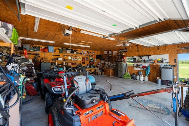 garage with a garage door opener and a workshop area