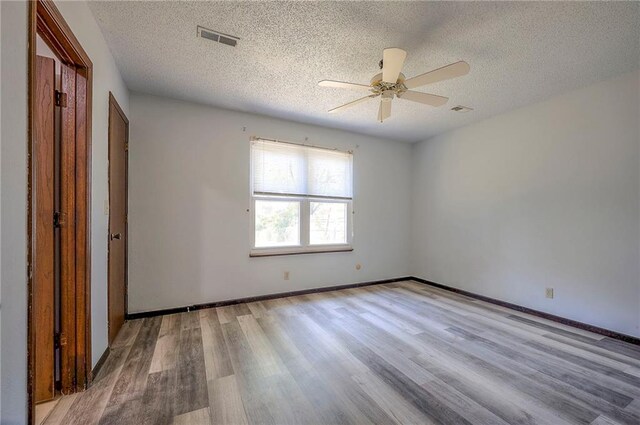 interior space with a textured ceiling, ceiling fan, and light hardwood / wood-style floors