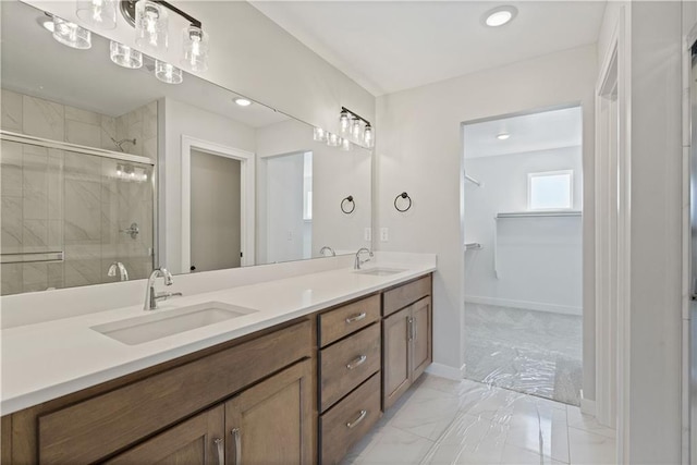 bathroom featuring double vanity, a stall shower, marble finish floor, and a sink