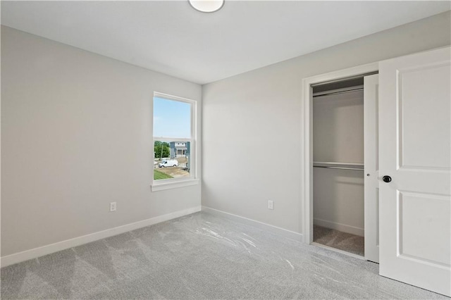 unfurnished bedroom featuring a closet, carpet, and baseboards