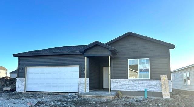 view of front of house featuring a garage and stone siding