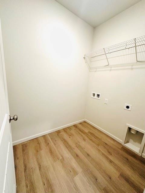 laundry area with laundry area, washer hookup, light wood-style floors, and hookup for an electric dryer