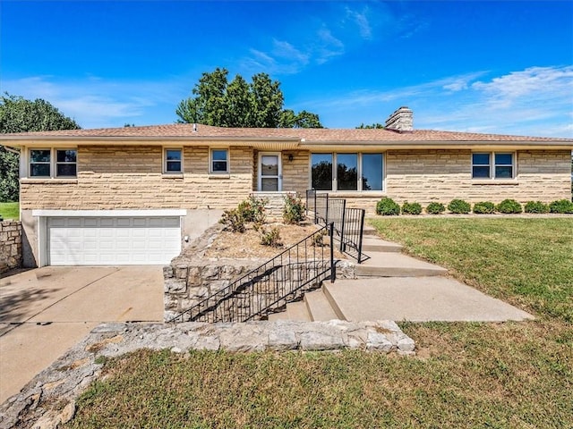 single story home with a front yard and a garage