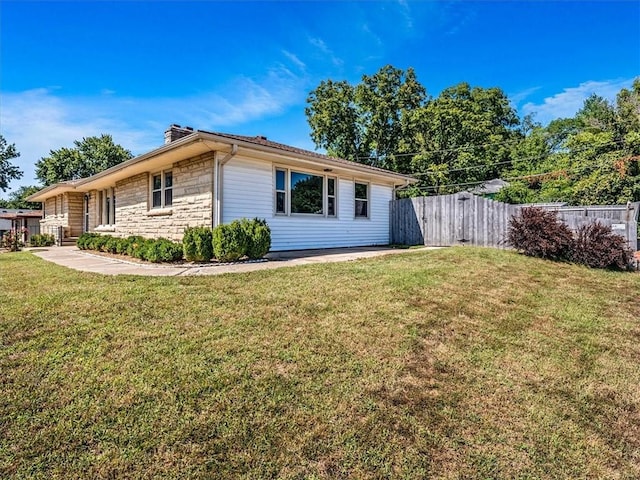 view of side of property with a yard