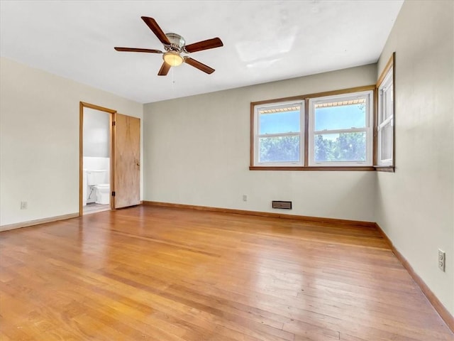 empty room with ceiling fan and light wood-type flooring