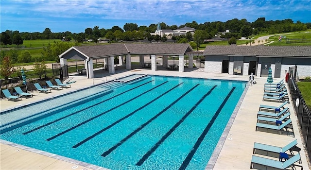 pool with fence, a gazebo, and a patio