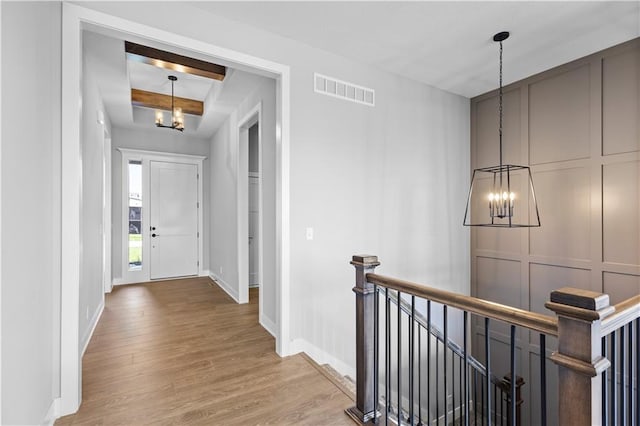 1511 SW Arbor Park Dr, Lees Summit, MO 64082 - corridor with an upstairs landing, a chandelier, wood finished floors, and a raised ceiling