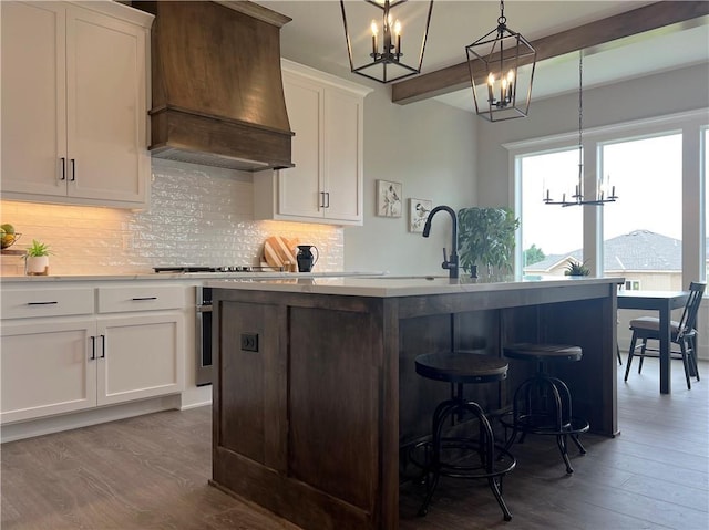 1511 SW Arbor Park Dr, Lees Summit, MO 64082 - kitchen with a chandelier, premium range hood, dark wood-style flooring, and backsplash
