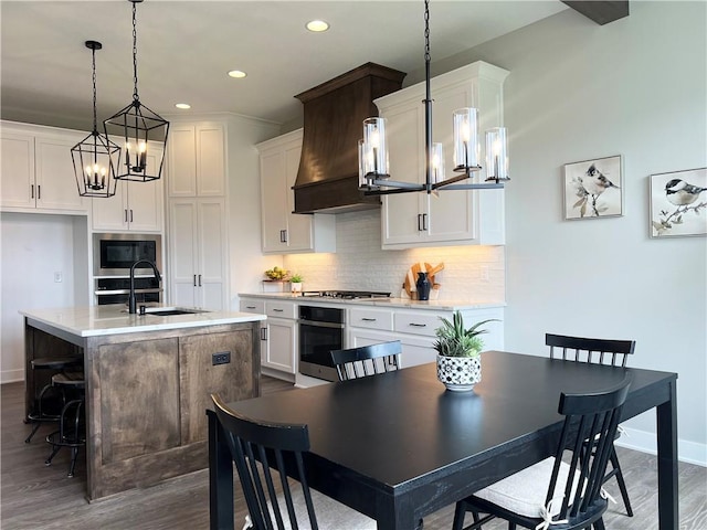 1511 SW Arbor Park Dr, Lees Summit, MO 64082 - kitchen with appliances with stainless steel finishes, a chandelier, dark wood-style flooring, white cabinetry, and recessed lighting
