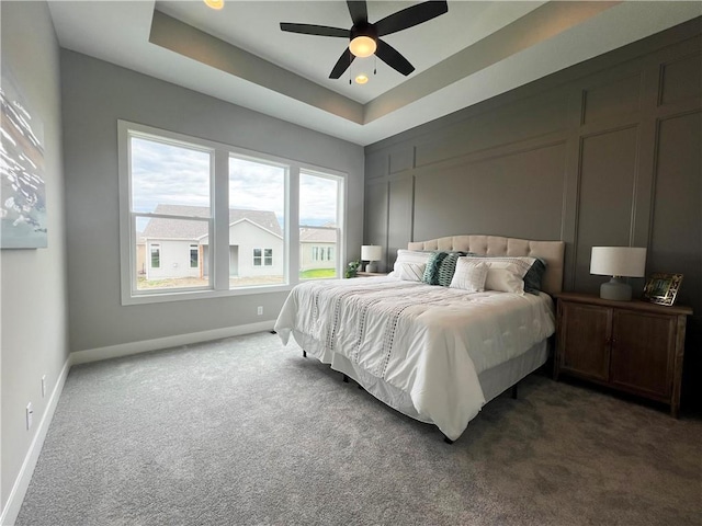 1511 SW Arbor Park Dr, Lees Summit, MO 64082 - carpeted bedroom featuring a tray ceiling and a ceiling fan