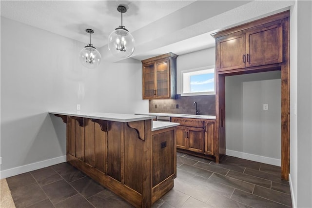 1511 SW Arbor Park Dr, Lees Summit, MO 64082 - kitchen with a peninsula, a breakfast bar, glass insert cabinets, light countertops, and decorative light fixtures