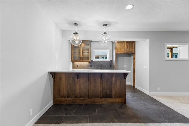 1511 SW Arbor Park Dr, Lees Summit, MO 64082 - kitchen with a peninsula, glass insert cabinets, a kitchen breakfast bar, a textured ceiling, and light countertops