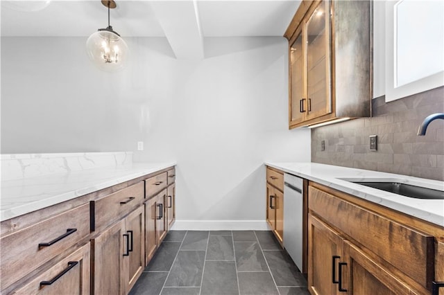 1511 SW Arbor Park Dr, Lees Summit, MO 64082 - kitchen featuring stainless steel dishwasher, backsplash, light stone counters, hanging light fixtures, and brown cabinetry