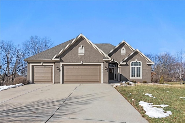 view of front of house with a garage and a front yard