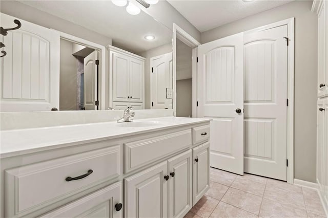 bathroom with tile patterned flooring and vanity