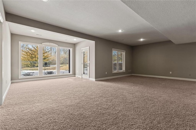 unfurnished living room with carpet and a textured ceiling