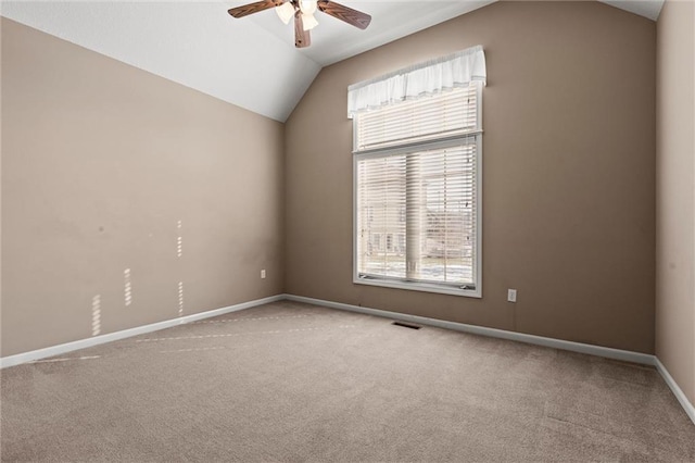 carpeted empty room featuring lofted ceiling and ceiling fan